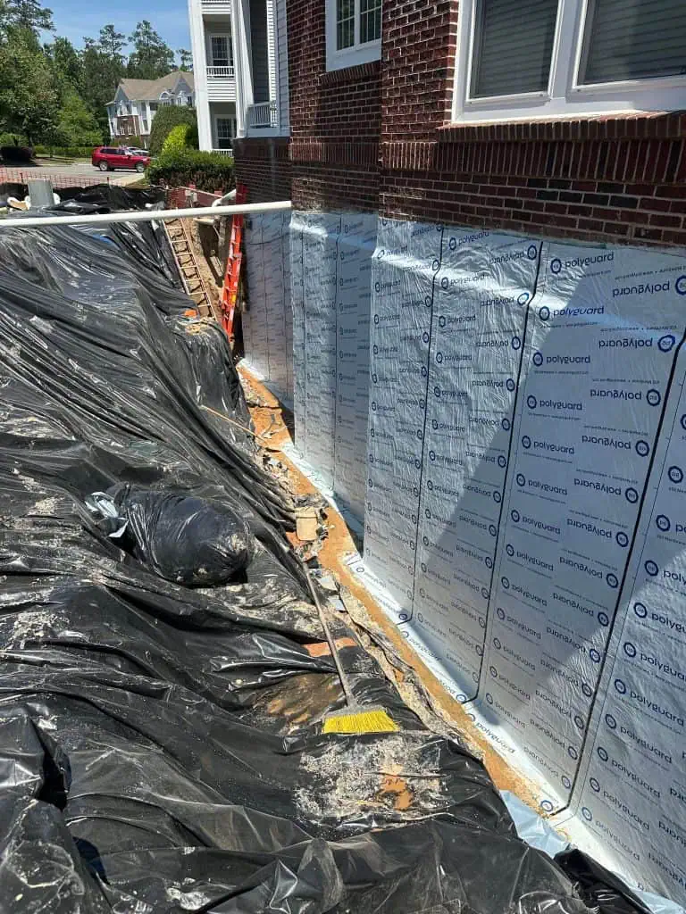 Waterproofing membrane installed on an excavated basement foundation wall
