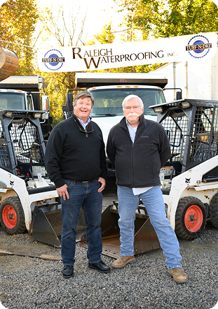 Raleigh Waterproofing Inc. team members standing beside company equipment